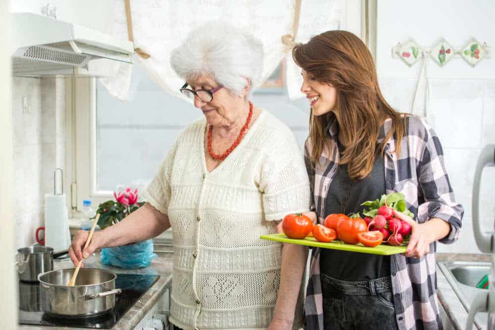 A woman undergoing stroke recovery relies on her support network to help her cook stroke-friendly meals